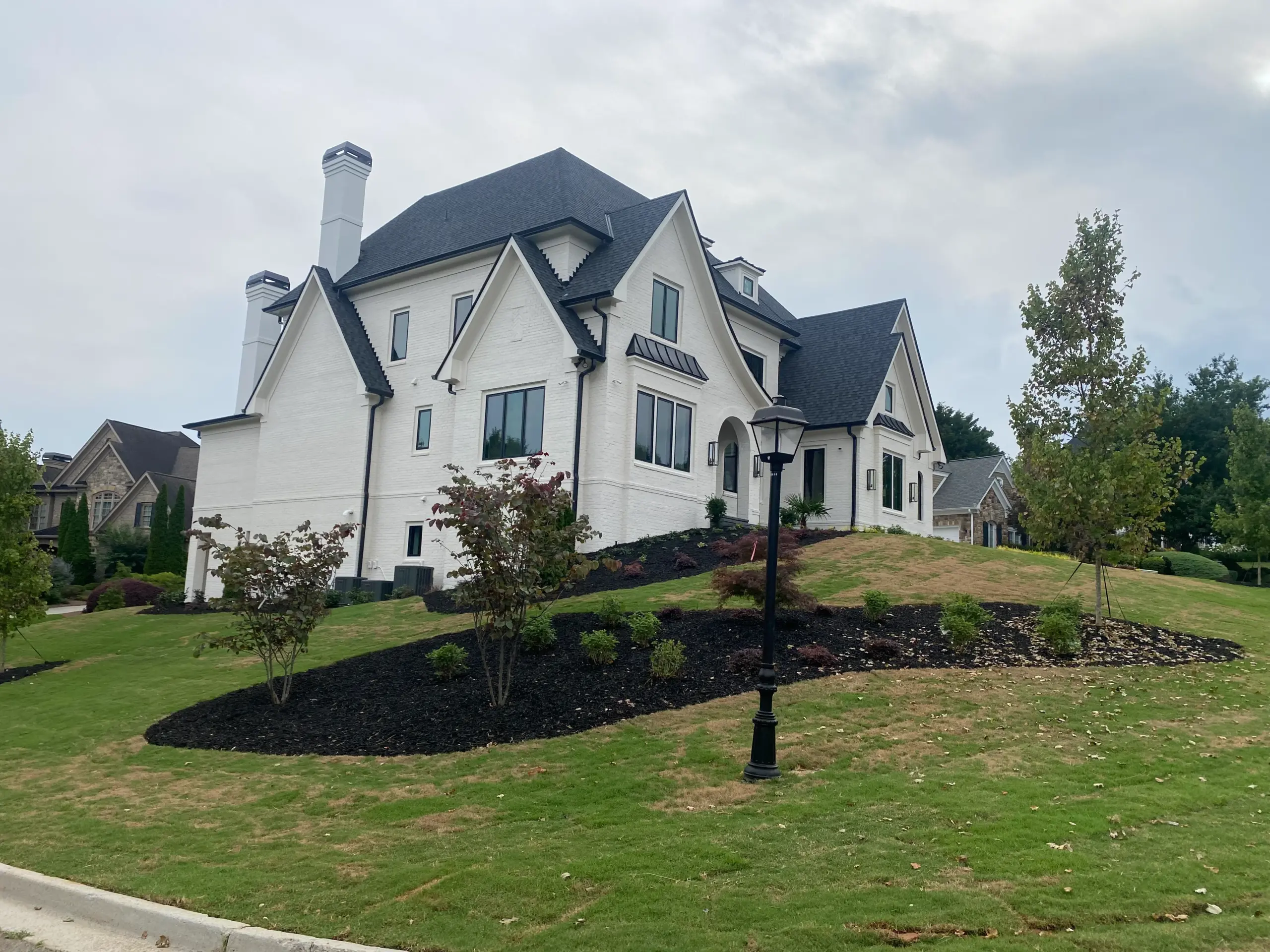 Rear lawn and landscaping of luxury home on elevated lot in Gwinnett County Georgia