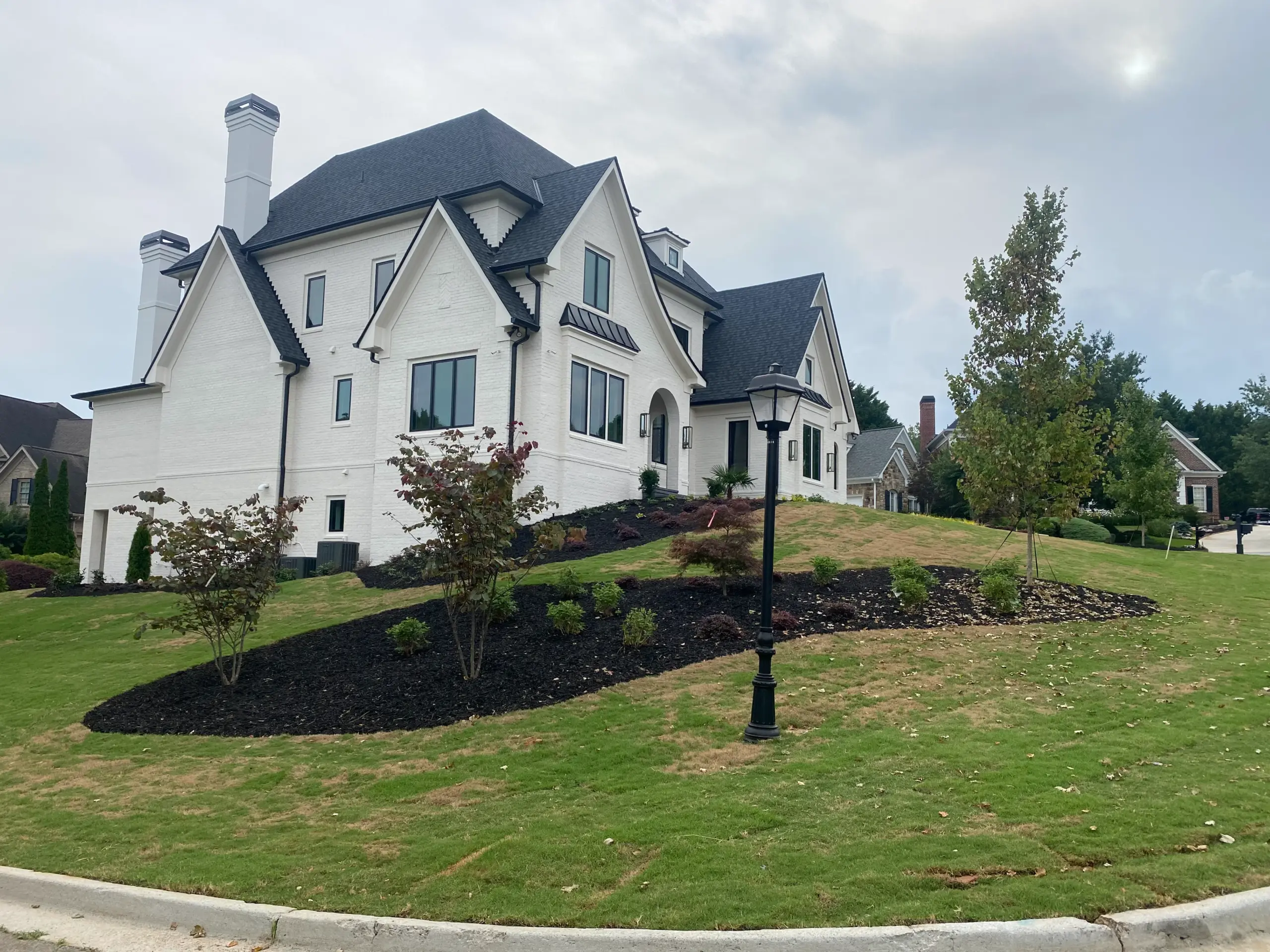 Full rear elevation of luxury home from landscaped lawn in Gwinnett Georgia