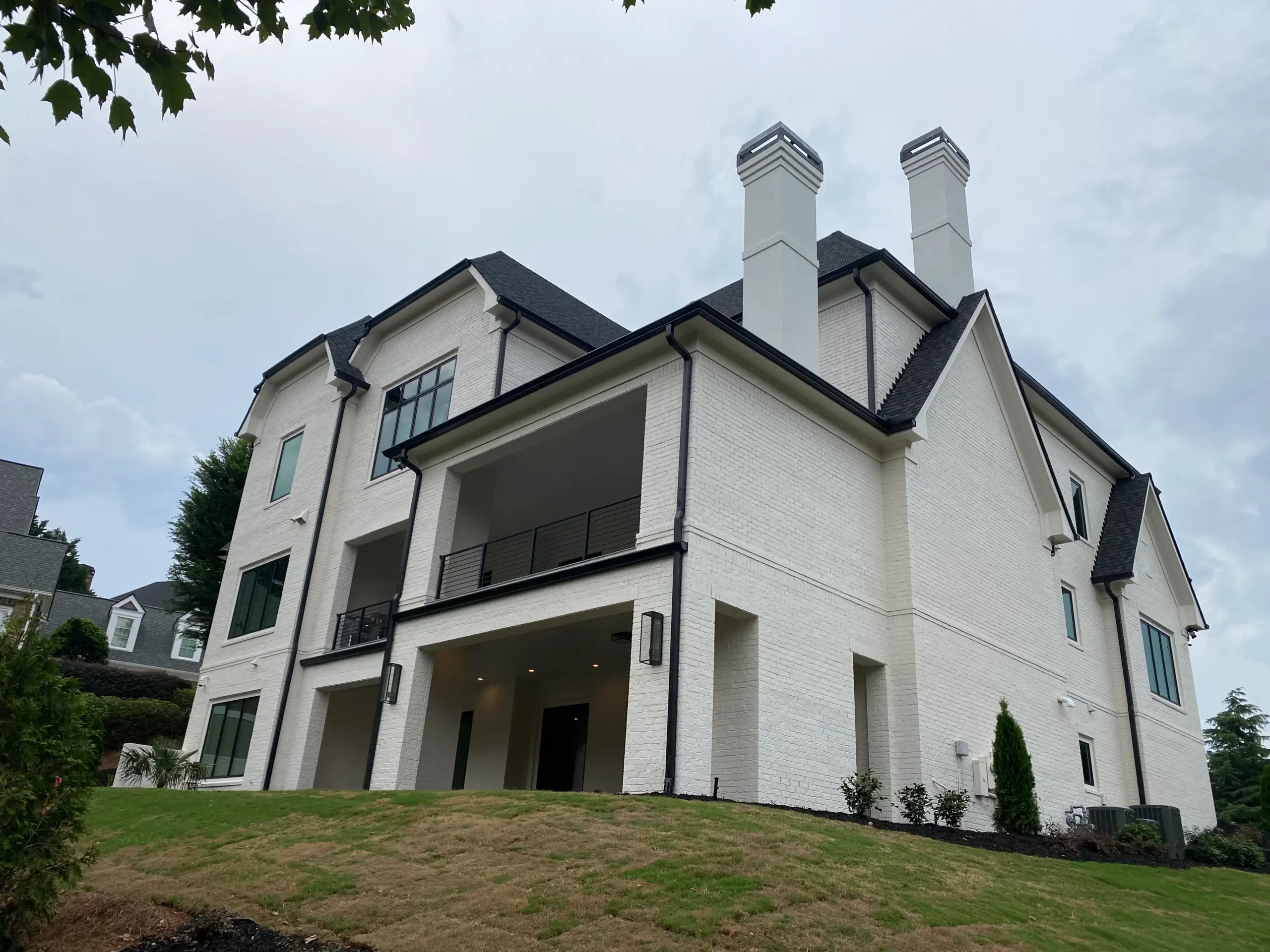 Luxury home rear elevation viewed from landscaped rear yard in Johns Creek Georgia
