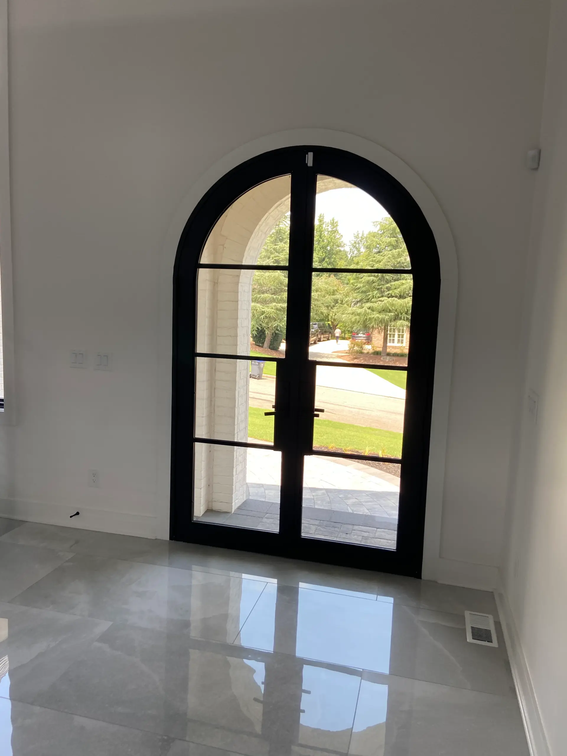 Grand Entrance — Spiral Staircase, Arched Doors & Designer Lighting