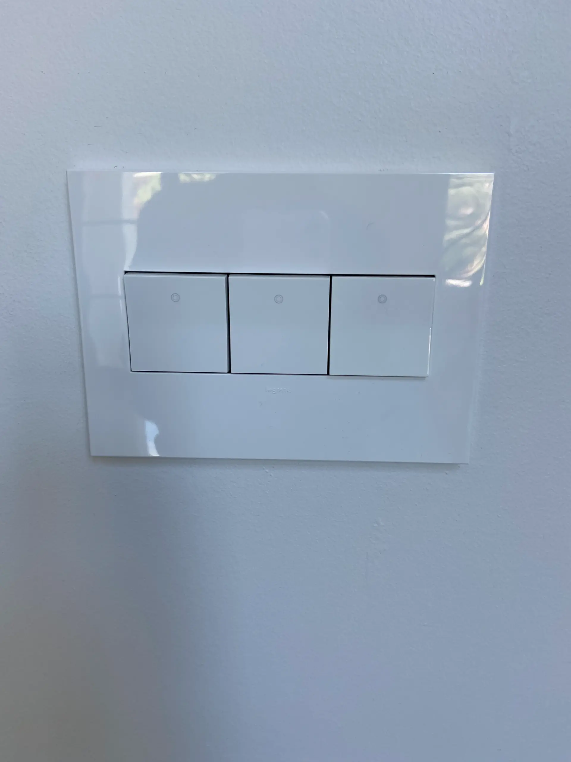 Custom curved navy bar cabinet with marble countertop and zebra print feature wall in luxury home entertainment space