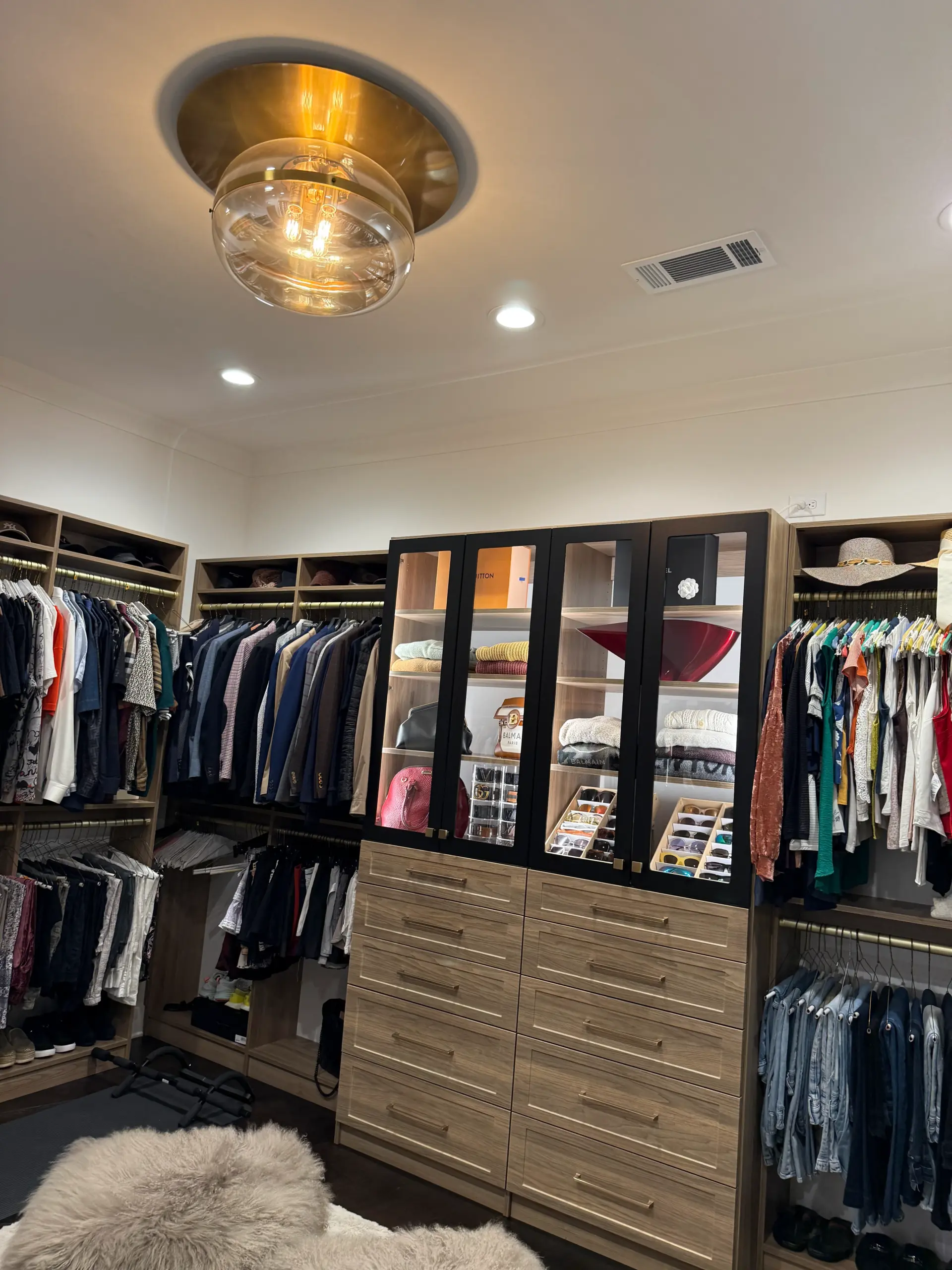 Custom walk-in closet with built-in cabinetry and island