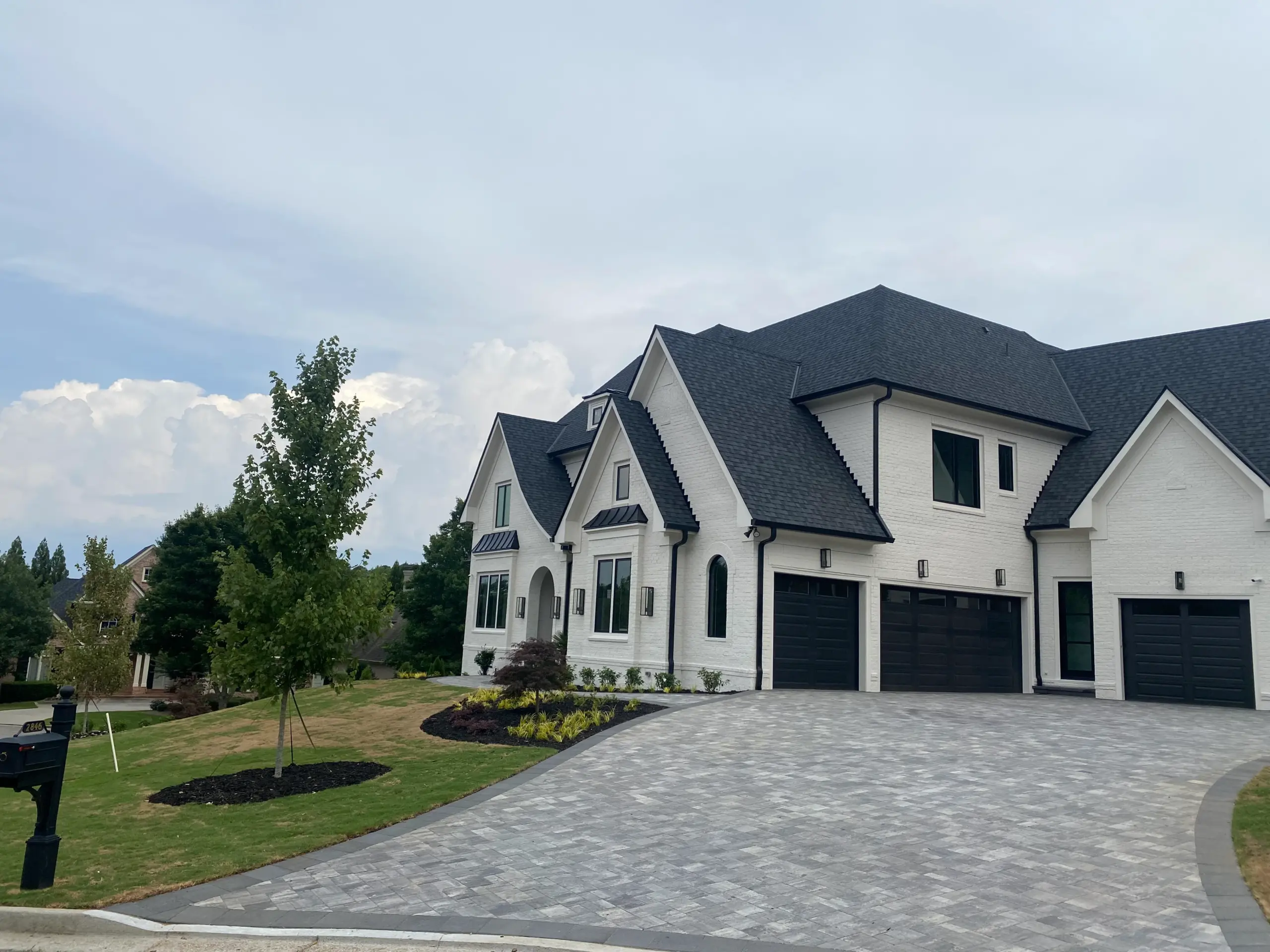 Wide view of paver driveway approach and luxury home exterior in Duluth Georgia