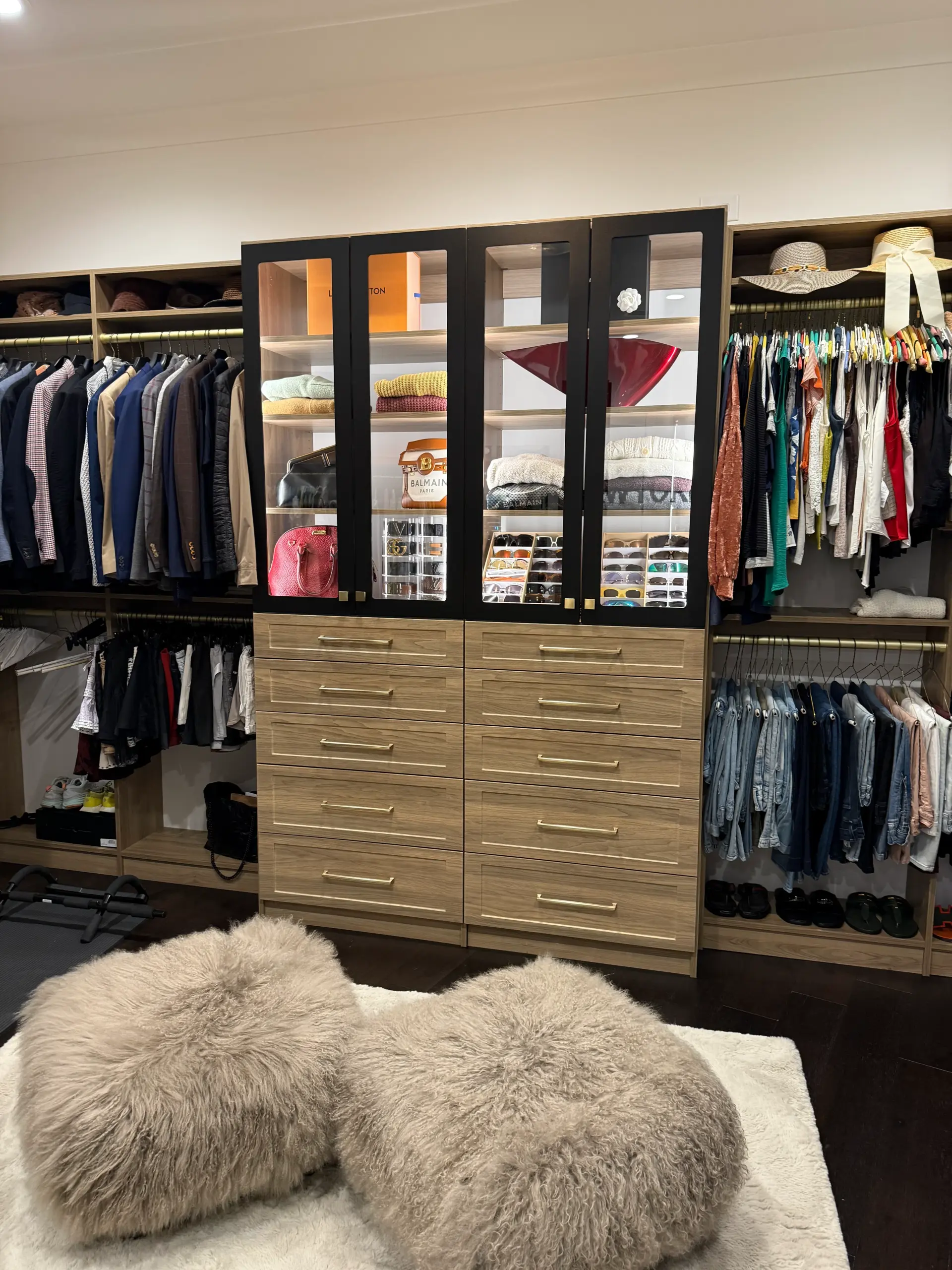 Completed his and hers custom walk-in closet with full cabinetry system