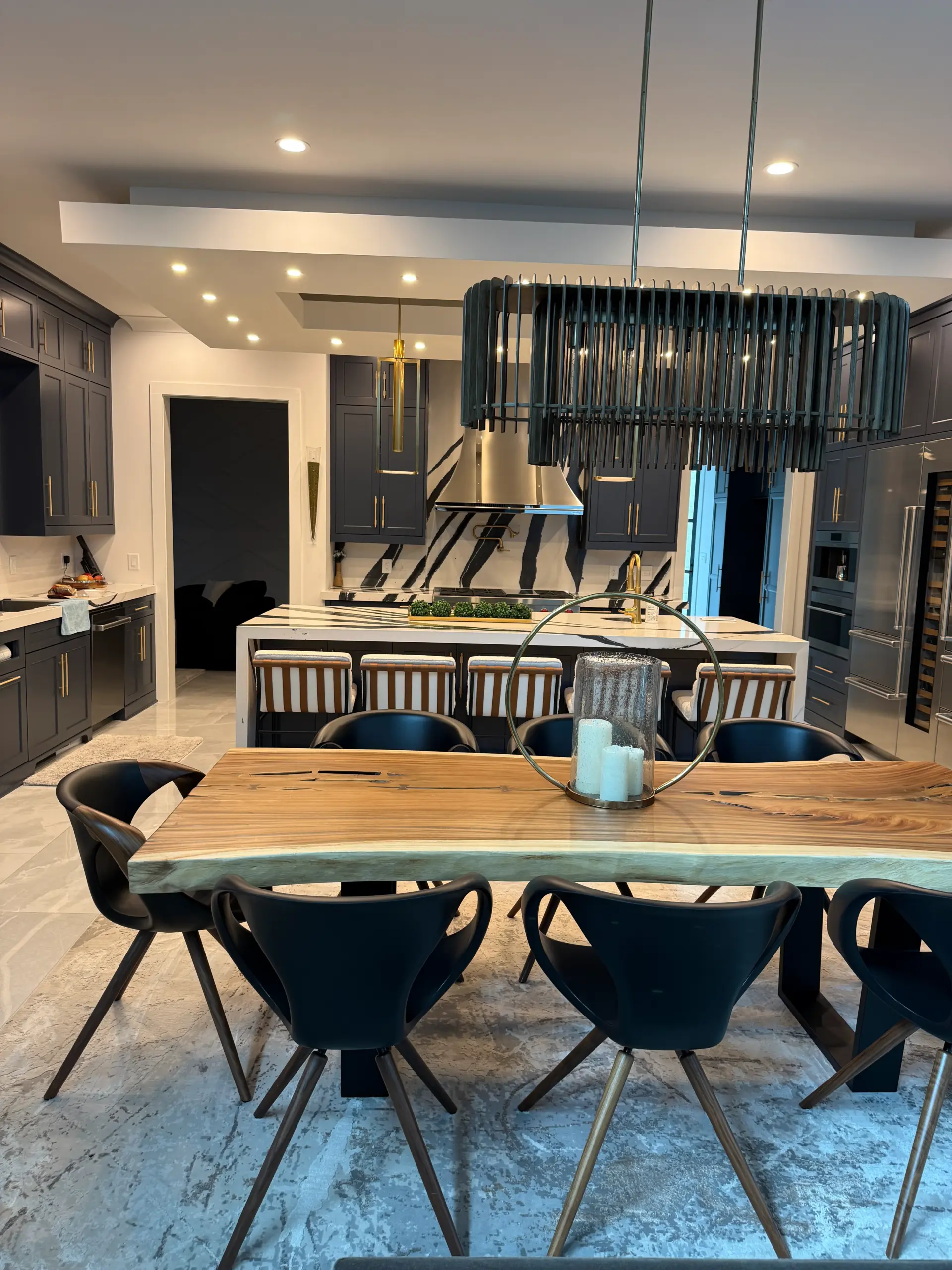 Gourmet kitchen with live edge dining table and island bar seating in luxury home Duluth Georgia