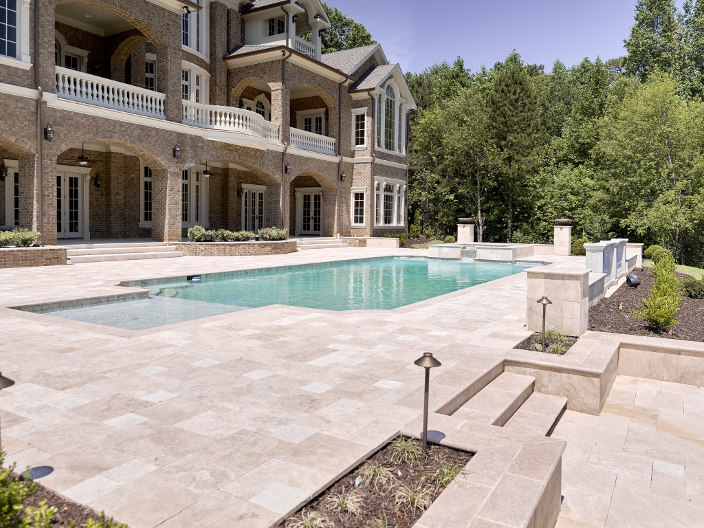 Classic luxury estate outdoor living — pool, patio, and landscaping